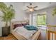Comfortable main bedroom with hardwood floors, a ceiling fan, and access to a screened patio at 850 Wingate Trl, Port Orange, FL 32128