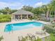 Community pool area featuring a large pool, lounge chairs, tables, and a covered seating area at 850 Wingate Trl, Port Orange, FL 32128
