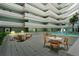 Bright and airy atrium with a sitting area, fountain, and greenery at 901 S Atlantic Ave # 202, Ormond Beach, FL 32176