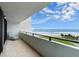 Balcony with a view of the ocean, lawn, and palm trees under sunny skies at 901 S Atlantic Ave # 202, Ormond Beach, FL 32176