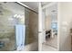 Bright bathroom offering glass shower doors, granite countertop, and ensuite access at 901 S Atlantic Ave # 202, Ormond Beach, FL 32176
