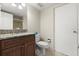 Cozy bathroom featuring granite countertop, wood cabinets, and neutral wall paint at 901 S Atlantic Ave # 202, Ormond Beach, FL 32176
