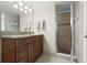 Bathroom featuring updated cabinetry, granite countertops, and walk-in shower at 901 S Atlantic Ave # 202, Ormond Beach, FL 32176