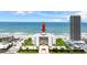 Exterior image of the Aliki Atrium building on a beach with an arrow pointing to the building at 901 S Atlantic Ave # 202, Ormond Beach, FL 32176