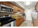 Updated kitchen featuring stainless steel appliances, granite countertops, and ample cabinet space at 901 S Atlantic Ave # 202, Ormond Beach, FL 32176