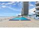 Relaxing in-ground pool with patio seating and umbrellas for a calming day with ocean views at 901 S Atlantic Ave # 202, Ormond Beach, FL 32176