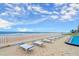 Oceanfront pool deck with beach access and lounge chairs under a sunny, partly cloudy sky at 901 S Atlantic Ave # 202, Ormond Beach, FL 32176