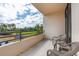 Relax on this inviting balcony with beautiful views of lush greenery and the blue sky above on a sunny day at 1 Oceans West Blvd # 1B5, Daytona Beach, FL 32118