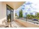 Cozy outdoor seating on balcony with views of sunny skies and nearby buildings, creating a serene urban retreat at 1 Oceans West Blvd # 1B5, Daytona Beach, FL 32118