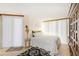 Bright bedroom with vertical blinds and wood-look flooring providing a serene escape at 1 Oceans West Blvd # 1B5, Daytona Beach, FL 32118