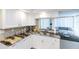 A well-lit kitchen featuring granite countertops, white cabinets, and a convenient pass-through to the living area at 1 Oceans West Blvd # 1B5, Daytona Beach, FL 32118