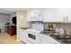 Efficient kitchen features white cabinets, black countertops, and view to living room with a pass through at 1 Oceans West Blvd # 1B5, Daytona Beach, FL 32118