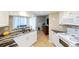 Modern kitchen featuring white cabinets, granite countertops, and stainless steel appliances; a culinary dream! at 1 Oceans West Blvd # 1B5, Daytona Beach, FL 32118