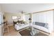 Bright and airy living room offering ceiling fan, comfortable couches, and natural light from the sliding glass doors at 1 Oceans West Blvd # 1B5, Daytona Beach, FL 32118