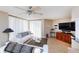 Inviting living room with modern ceiling fan, comfortable seating, and sliding doors for natural light and access at 1 Oceans West Blvd # 1B5, Daytona Beach, FL 32118