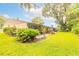 Well-maintained backyard with healthy grass and a beautiful, mature shade tree at 1237 Charter Oaks Cir, Daytona Beach, FL 32117