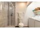 Well-lit bathroom equipped with a shower featuring a glass door and a convenient washer and dryer at 1237 Charter Oaks Cir, Daytona Beach, FL 32117