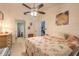 Relaxing bedroom features a ceiling fan, tile flooring, and an ensuite bathroom, creating a private retreat at 1237 Charter Oaks Cir, Daytona Beach, FL 32117