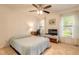 Bright bedroom with tile flooring, a ceiling fan, and natural light from the windows at 1237 Charter Oaks Cir, Daytona Beach, FL 32117