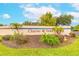 The Charter Oaks community sign surrounded by lush landscaping and palm trees on a sunny day at 1237 Charter Oaks Cir, Daytona Beach, FL 32117