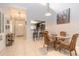 Cozy dining area provides bar seating and views of the kitchen and entry, illuminated by a pendant light at 1237 Charter Oaks Cir, Daytona Beach, FL 32117