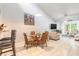 Charming dining area showcasing a table with wicker chairs and views into the living room and kitchen at 1237 Charter Oaks Cir, Daytona Beach, FL 32117