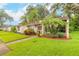 Inviting front exterior with manicured landscaping, sidewalk, and curb appeal at 1237 Charter Oaks Cir, Daytona Beach, FL 32117