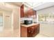 Spacious kitchen featuring dark cabinets, granite countertops, and stainless steel microwave at 1237 Charter Oaks Cir, Daytona Beach, FL 32117