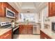 Modern kitchen with stainless steel appliances, granite countertops, and ample cabinet space at 1237 Charter Oaks Cir, Daytona Beach, FL 32117