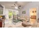 Comfortable living room features access to a screened lanai and offers a glimpse into an adjacent bedroom at 1237 Charter Oaks Cir, Daytona Beach, FL 32117