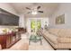 Bright living room featuring tile floors, a ceiling fan, a fireplace and sliding glass doors to the lanai at 1237 Charter Oaks Cir, Daytona Beach, FL 32117