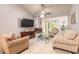 Bright living room with a cozy fireplace, tile flooring, and access to the outdoor space at 1237 Charter Oaks Cir, Daytona Beach, FL 32117