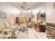 Open concept living room with a fireplace, tile floors, a ceiling fan, and an open view of the dining area at 1237 Charter Oaks Cir, Daytona Beach, FL 32117