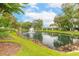 Scenic view of a pond with a fountain surrounded by lush landscaping at 1237 Charter Oaks Cir, Daytona Beach, FL 32117