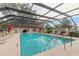 Community pool with ample seating and a covered enclosure at 1237 Charter Oaks Cir, Daytona Beach, FL 32117