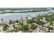 An aerial view of a waterfront neighborhood featuring private docks and lush landscaping near the water at 132 E Turgot Ave, Edgewater, FL 32132