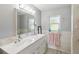 Well-lit bathroom featuring a double sink vanity with a large mirror at 132 E Turgot Ave, Edgewater, FL 32132