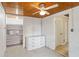 Bedroom with white walls, tile floor, ceiling fan, and built in storage with drawers and shelves at 132 E Turgot Ave, Edgewater, FL 32132