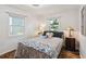 Comfortable bedroom with natural light, decorated with unique touches and an accent rug at 132 E Turgot Ave, Edgewater, FL 32132