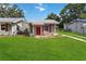 Charming home featuring a well-maintained lawn and a quaint front porch at 132 E Turgot Ave, Edgewater, FL 32132