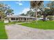 Inviting single-story home with lush green lawn and mature trees enhancing its curb appeal at 132 E Turgot Ave, Edgewater, FL 32132