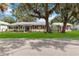 Charming single-story home featuring a well-manicured lawn, mature trees, and inviting curb appeal at 132 E Turgot Ave, Edgewater, FL 32132