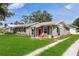 Charming exterior view highlighting the well-maintained lawn and cozy curb appeal of the home at 132 E Turgot Ave, Edgewater, FL 32132