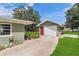 Detached garage has a red door and white garage door at 132 E Turgot Ave, Edgewater, FL 32132