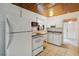 Functional kitchen space with white appliances and cabinetry, ready for culinary endeavors at 132 E Turgot Ave, Edgewater, FL 32132