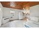 Bright living room with tiled floors adjacent to a white kitchen and a couch at 132 E Turgot Ave, Edgewater, FL 32132