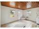Cozy living room featuring tile floors, a white brick accent wall and ample natural light at 132 E Turgot Ave, Edgewater, FL 32132