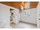 Cozy living room with white brick walls, wood ceiling, and access to the kitchen at 132 E Turgot Ave, Edgewater, FL 32132