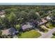 An aerial view showing the single-story home nestled among mature trees in a quiet neighborhood at 1421 Pine Tree Dr, Edgewater, FL 32132