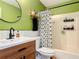 Stylish bathroom featuring modern fixtures, a wood vanity, with a shower and storage rack at 1421 Pine Tree Dr, Edgewater, FL 32132